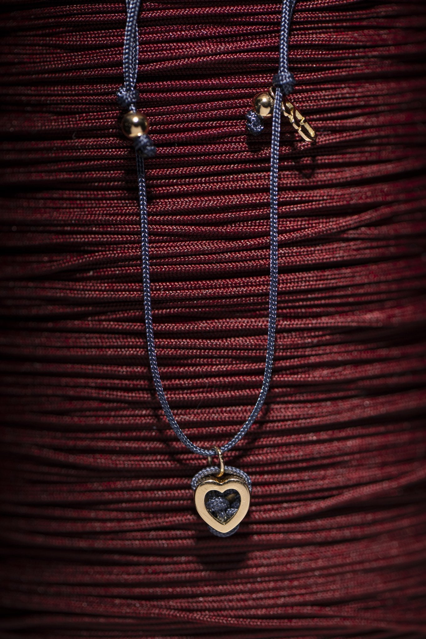Concordia heart bracelet styled on red cord skein