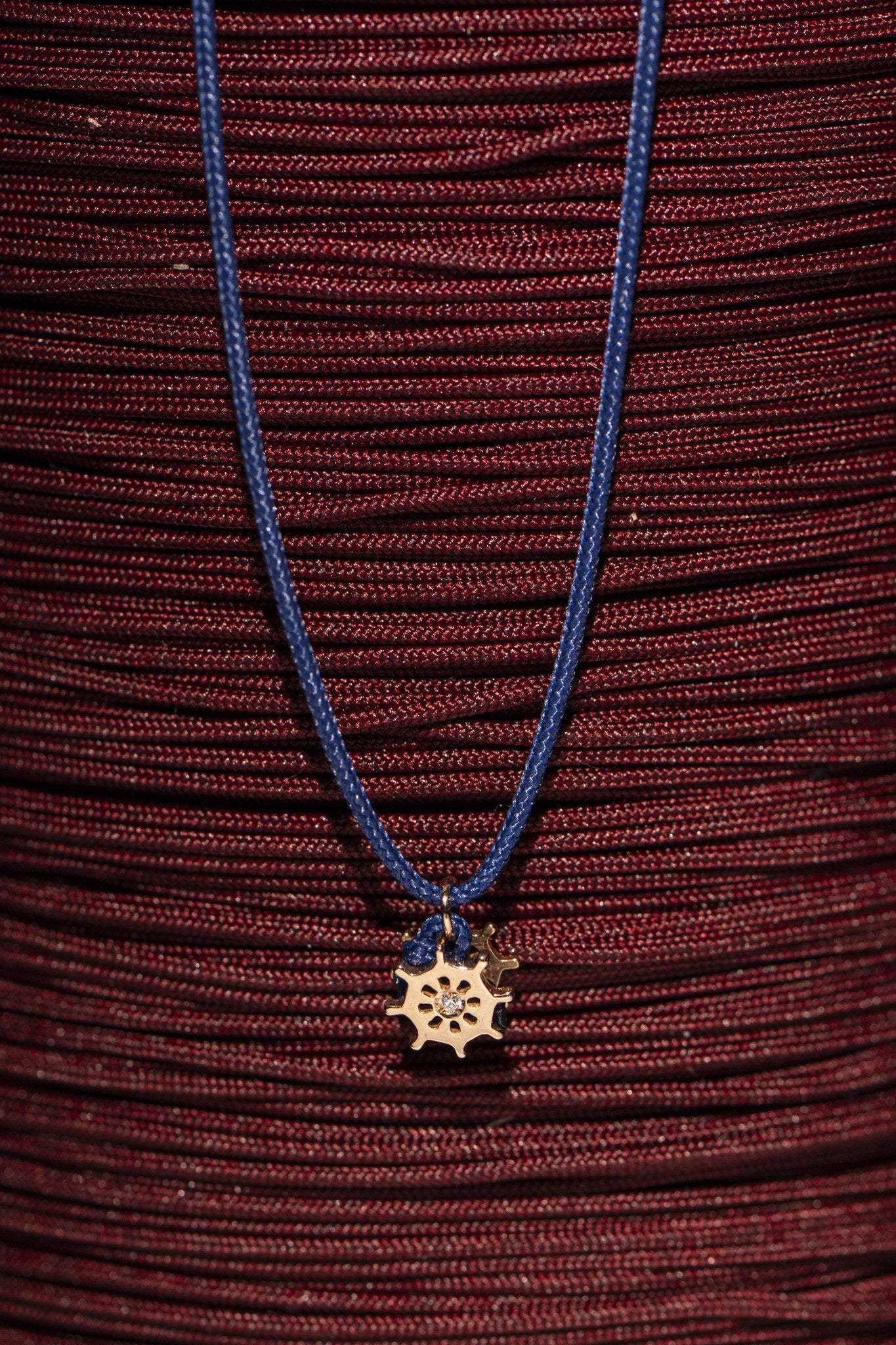 Concordia helm bracelet styled on red cord skein